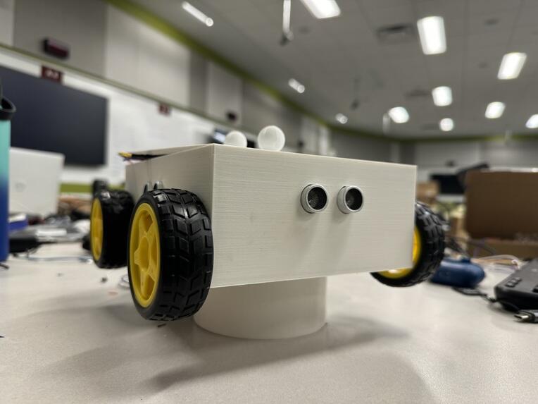 The WorldWide Rover: a 3D-printed chassis with yellow wheels and ultrasonic sensors